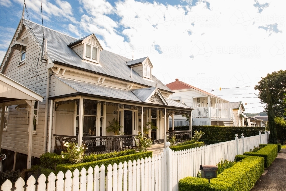 house with dormer windows on a street on a sunny day - Australian Stock Image