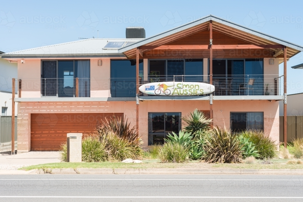 House with hand painted surfboard supporting Aussie teams - Australian Stock Image