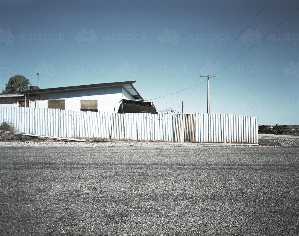 House with metal fence in outback town - Australian Stock Image