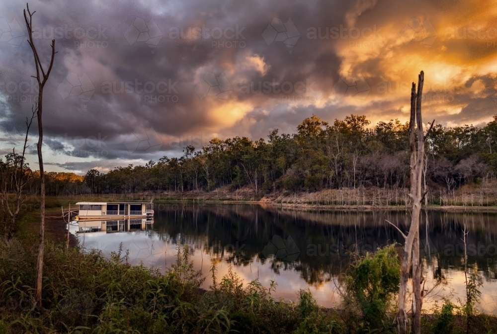 Houseboat at Sunset on Lake Monduran, QLD - Australian Stock Image