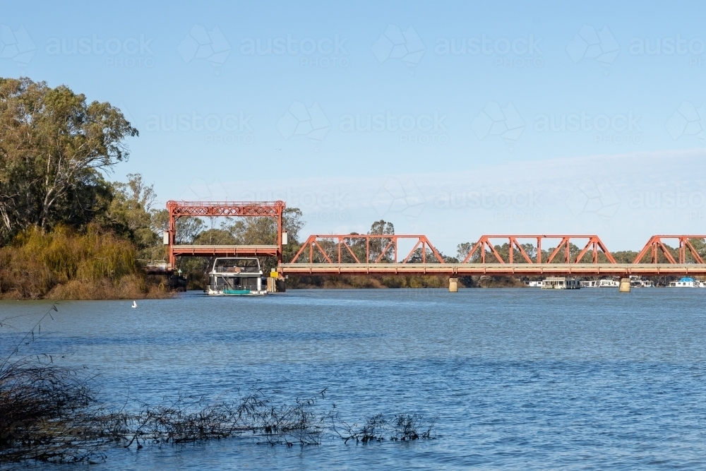 Houseboat under bridge - Australian Stock Image