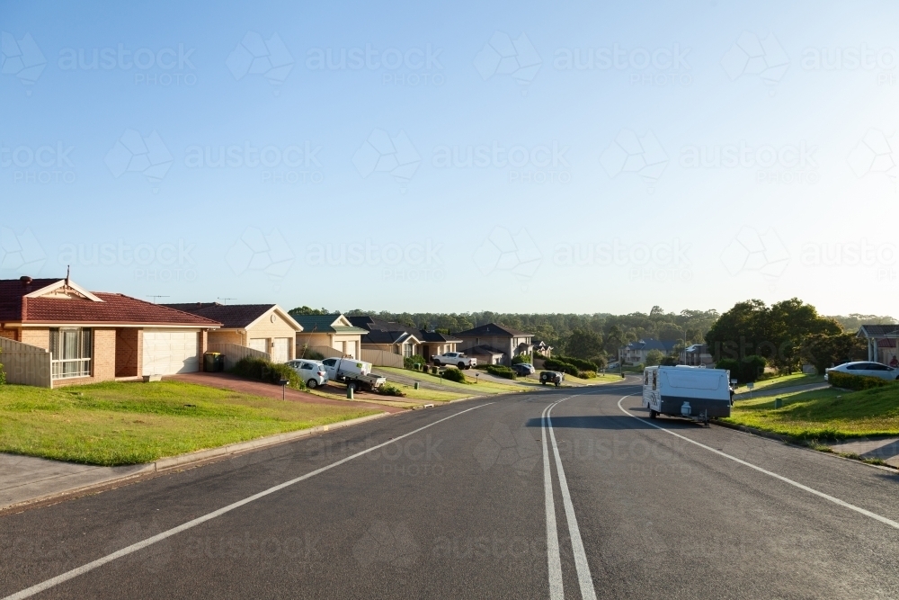Houses along quiet Aussie suburban street in the morning light - Australian Stock Image