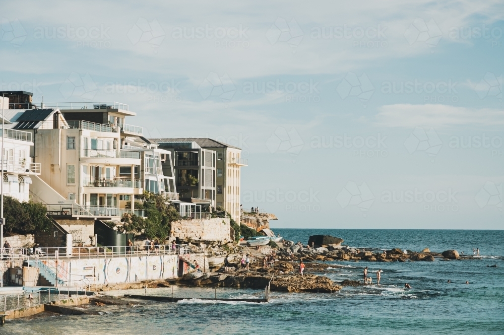 houses and apartments on the edge of Bondi Beach north side of the ocean - Australian Stock Image