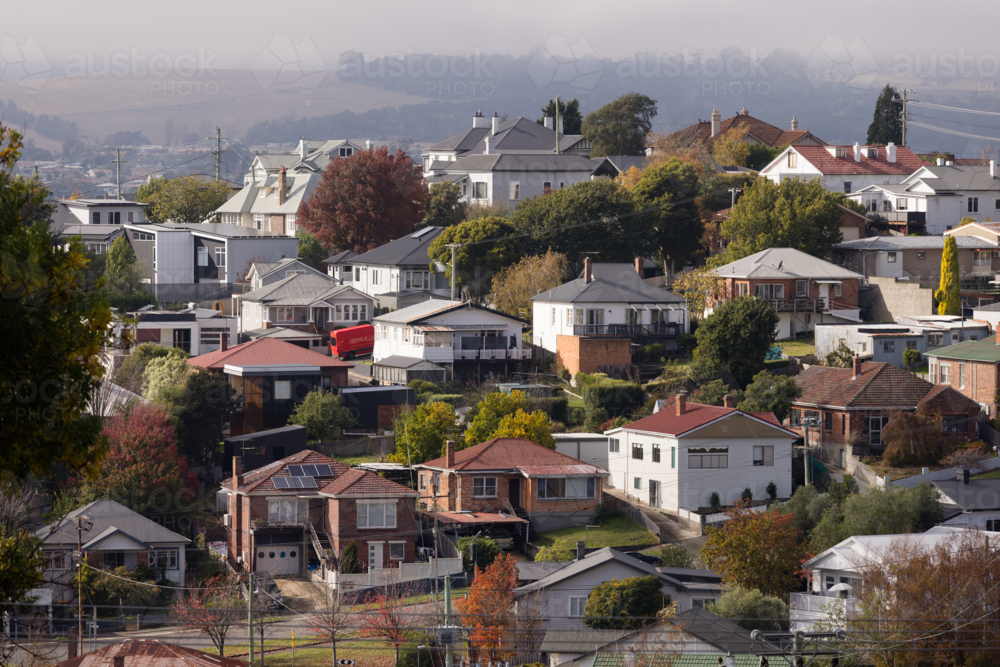 Houses over a hillside area of East Launceston in autumn - Australian Stock Image