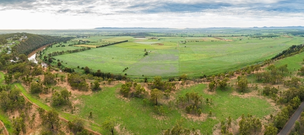 Houses with view over cliff and green Long Point farm paddocks - Australian Stock Image
