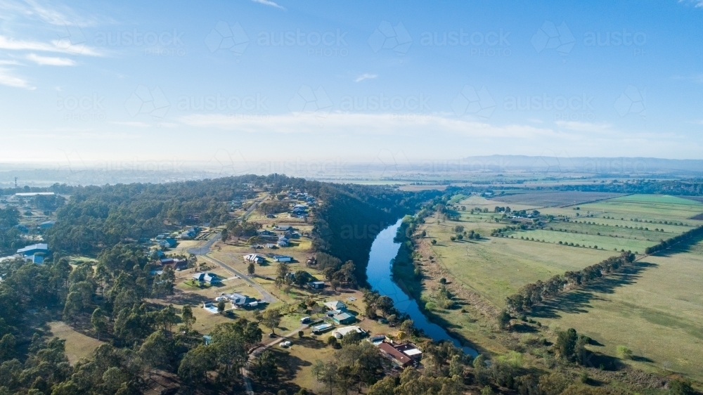 Hunter river with farm paddocks beside and out of town acreages - Australian Stock Image