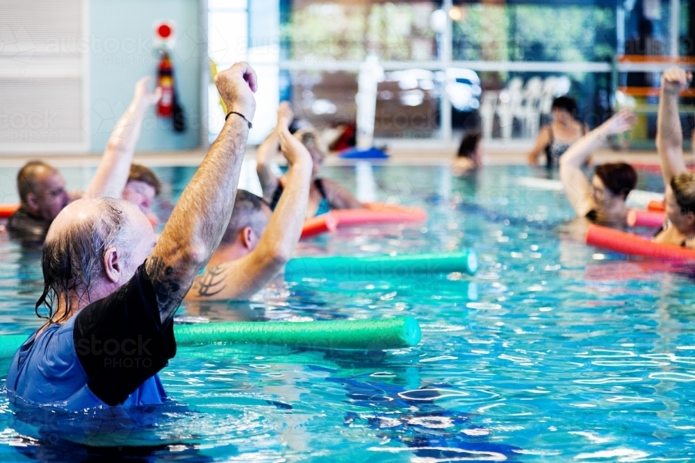 Image of Hydrotherapy class in local public pool - Austockphoto