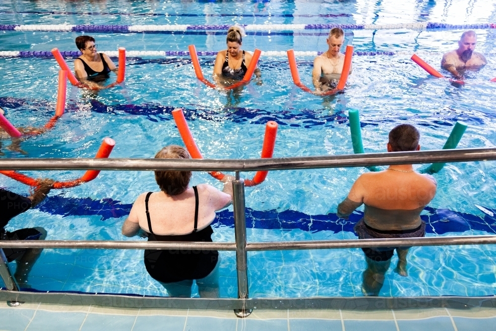Image of Hydrotherapy class in local public pool - Austockphoto