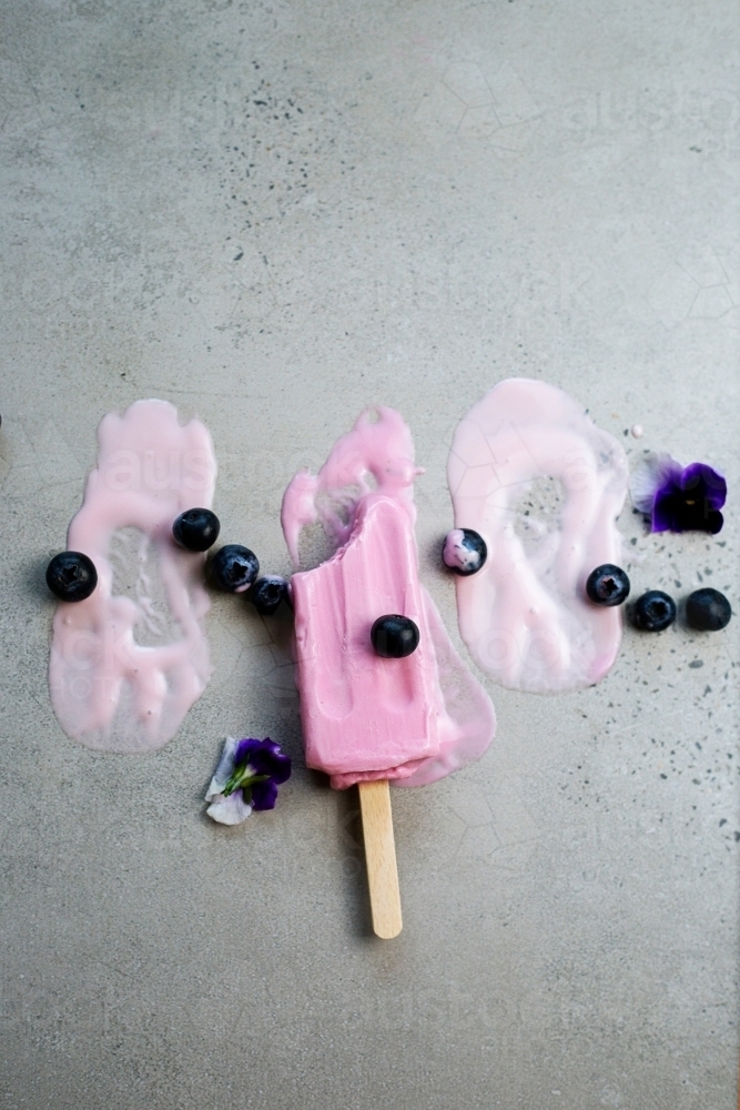 Ice cream on stick melting - Australian Stock Image