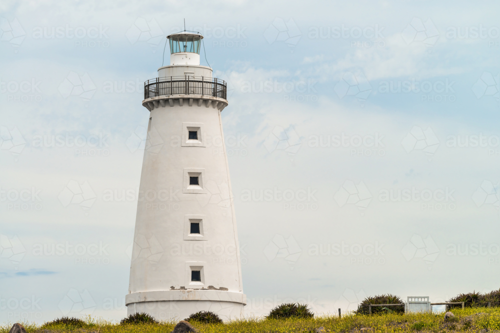 Iconic Cape Willoughby lighthouse viewed against sky with clouds on a day, Kangaroo Island - Australian Stock Image