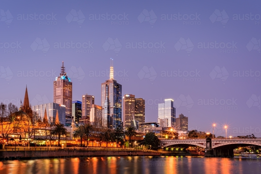 Illuminated Melbourne City skyline by Princes Bridge Over Yarra River Against Clear Sky - Australian Stock Image