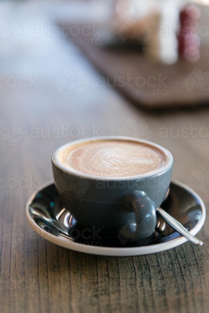 Image of a coffee on a wooden table - Australian Stock Image