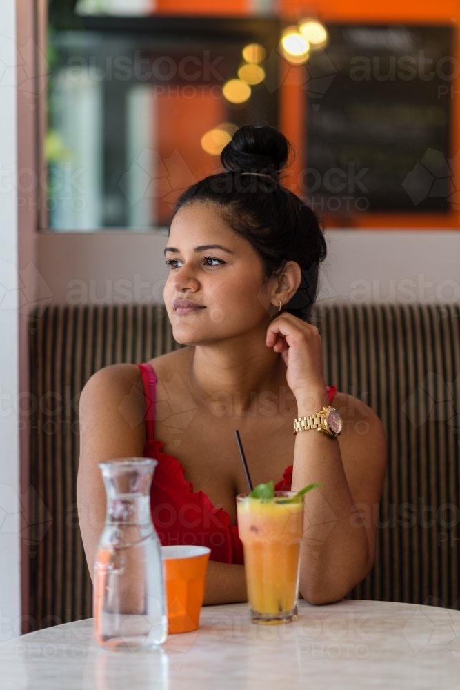 Indian woman in cafe - Australian Stock Image