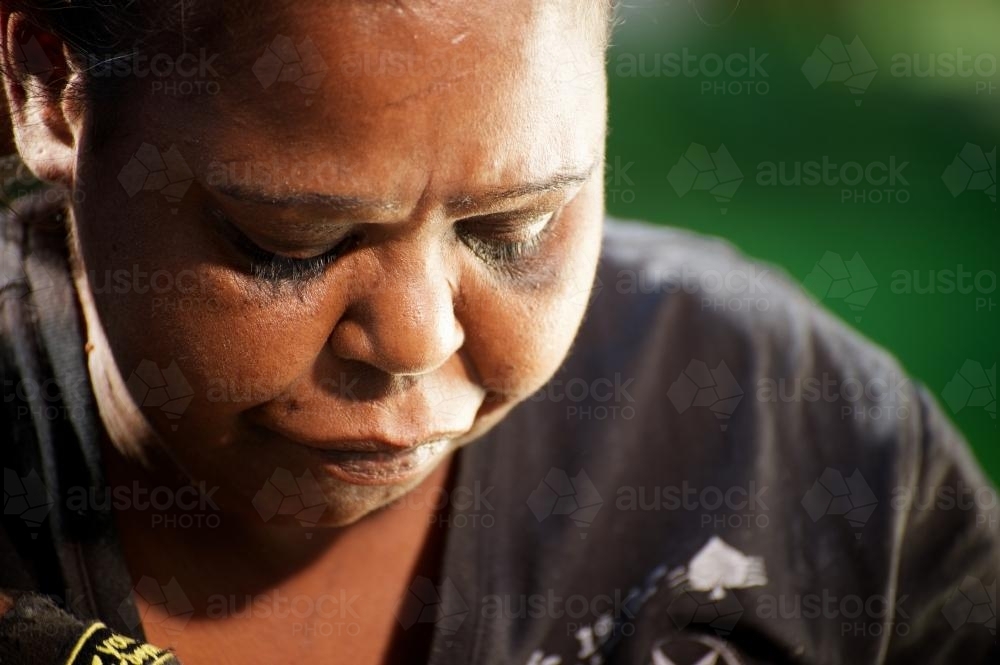 Indigenous Australian Woman Looking Downwards - Australian Stock Image