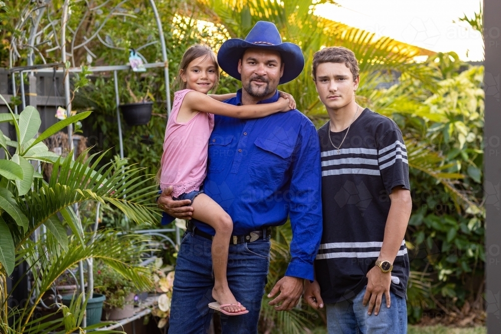 indigenous father with his two children - Australian Stock Image