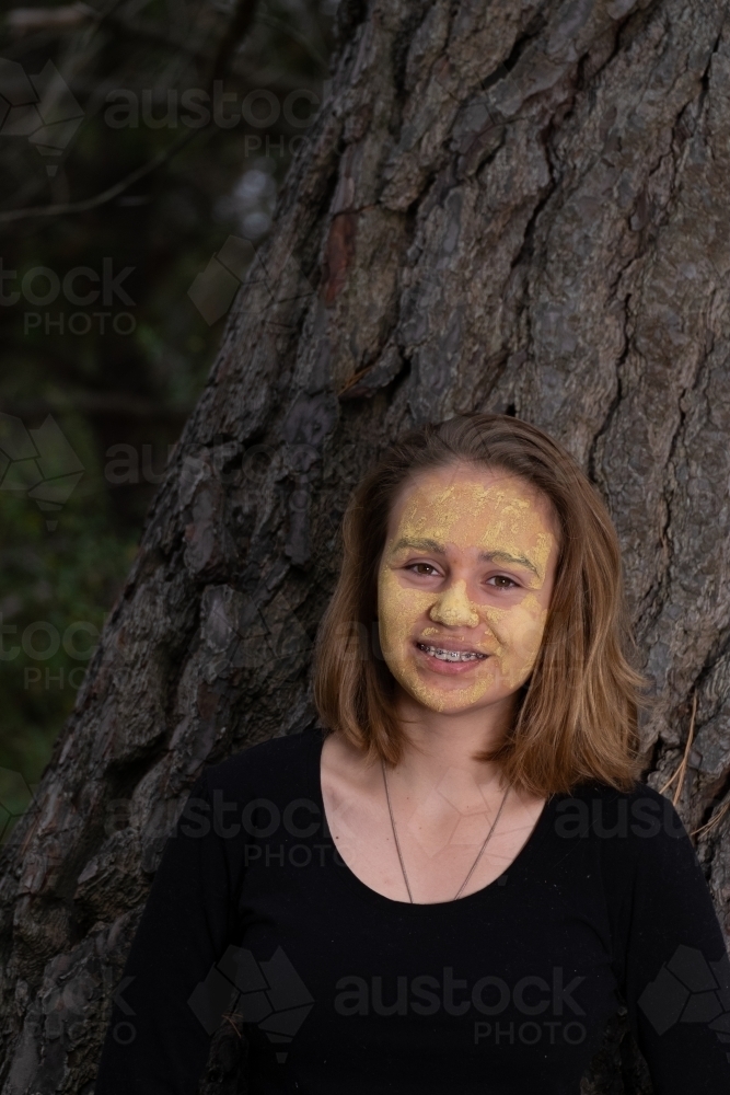 Indigenous girl near an old tree - Australian Stock Image