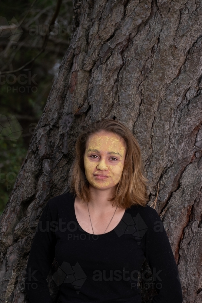 Indigenous girl near an old tree - Australian Stock Image