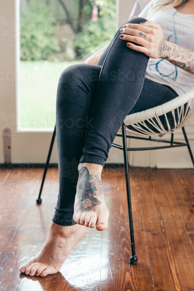 Individuality shown close up with tattoos on a young woman's foot - Australian Stock Image