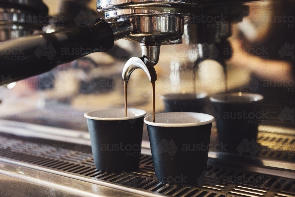 Industrial coffee machine making two cups of espresso - Australian Stock Image
