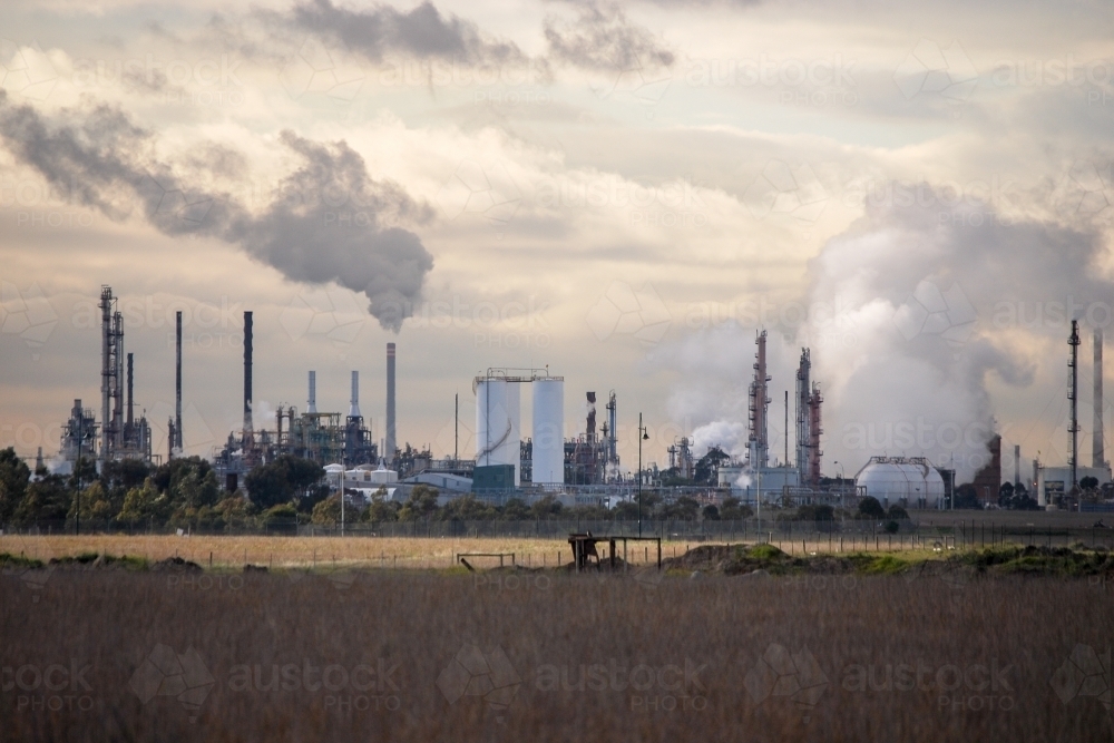 Industrial site sending pollution into the sky - Australian Stock Image