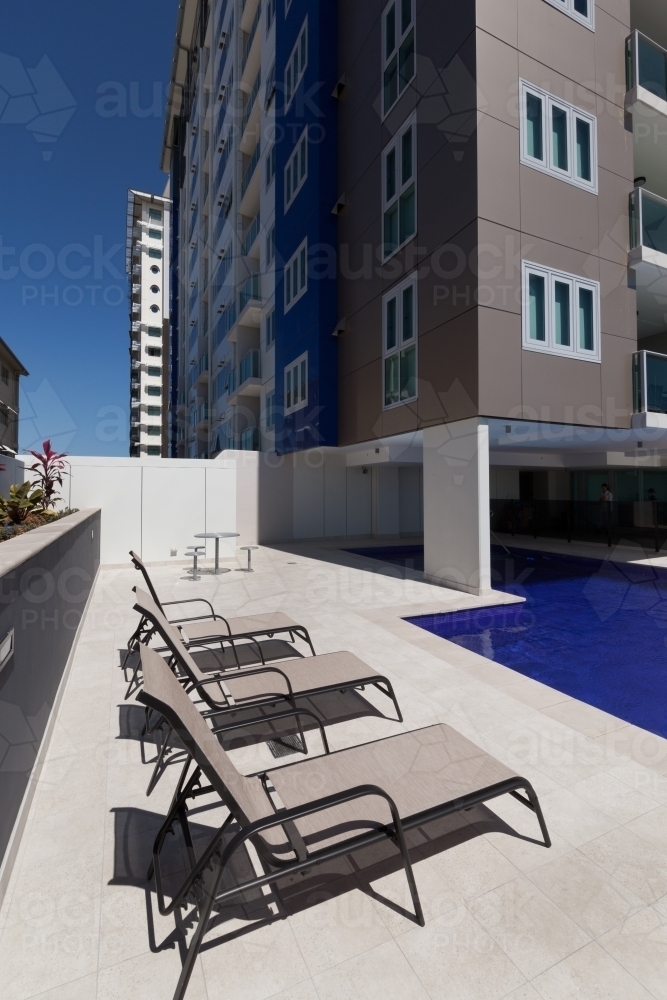 Inner city building with pool and sun lounges - Australian Stock Image