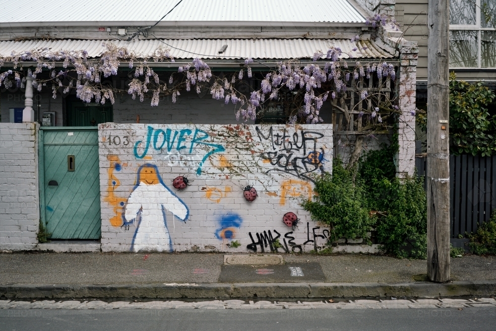 Inner Suburban Terrace House with Wisteria and Graffiti - Australian Stock Image