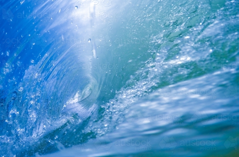 Inside a vibrant blue barrel wave - Australian Stock Image