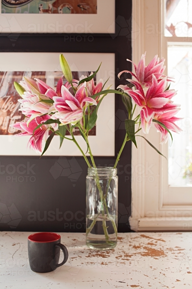 Interior vignette of flowers and coffee mug - Australian Stock Image