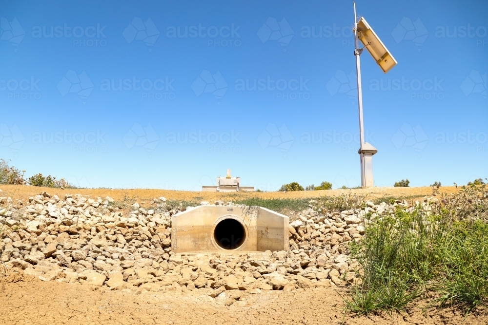 Irrigation channel stop with solar panel. No water during dry summer drought. - Australian Stock Image