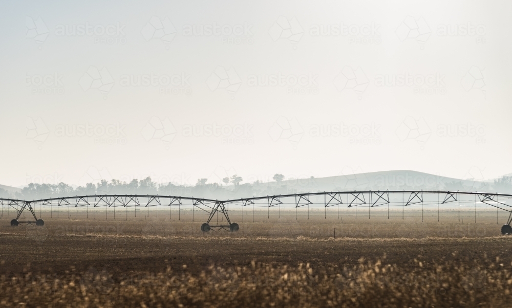 irrigation equipment on the land early morning - Australian Stock Image