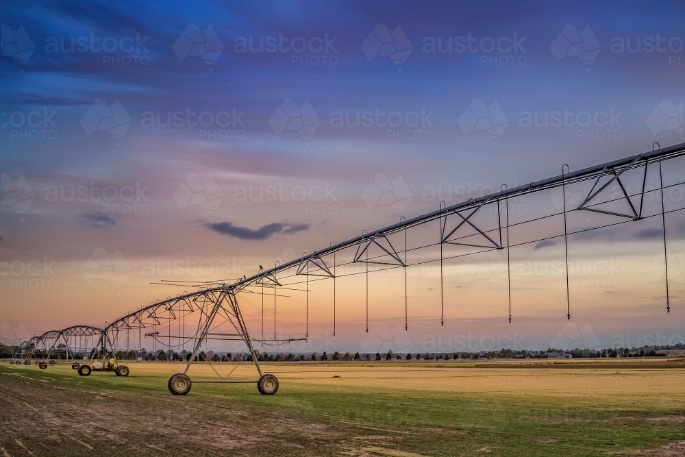 Irrigation machinery in paddock at dusk - Australian Stock Image