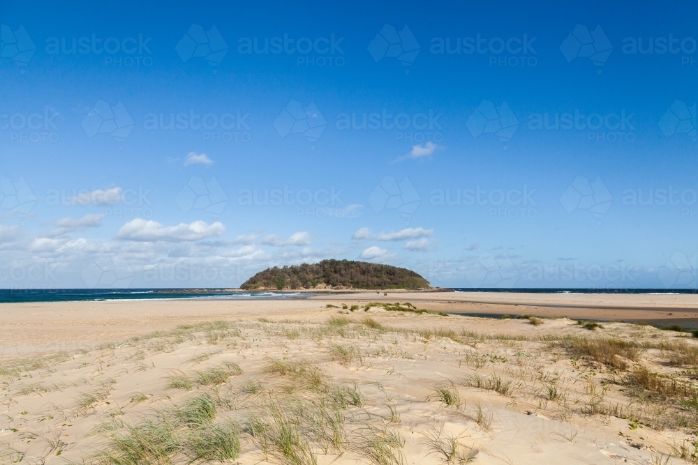 Island where Tabourie Creek flows into the ocean and blue sky - Australian Stock Image