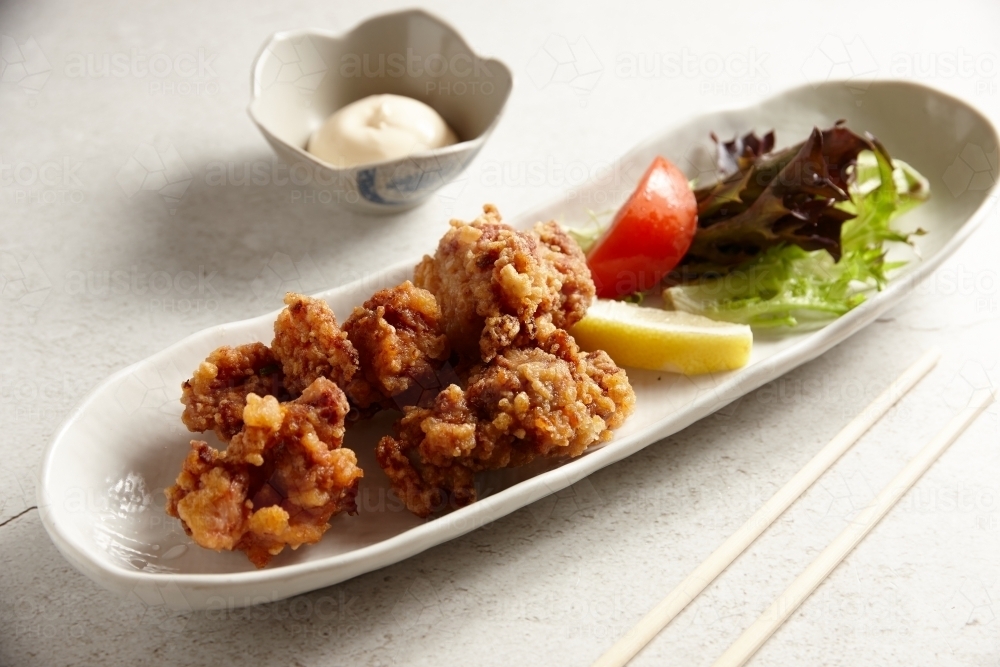 Image of Japanese fried chicken with tomato lemon lettuce and