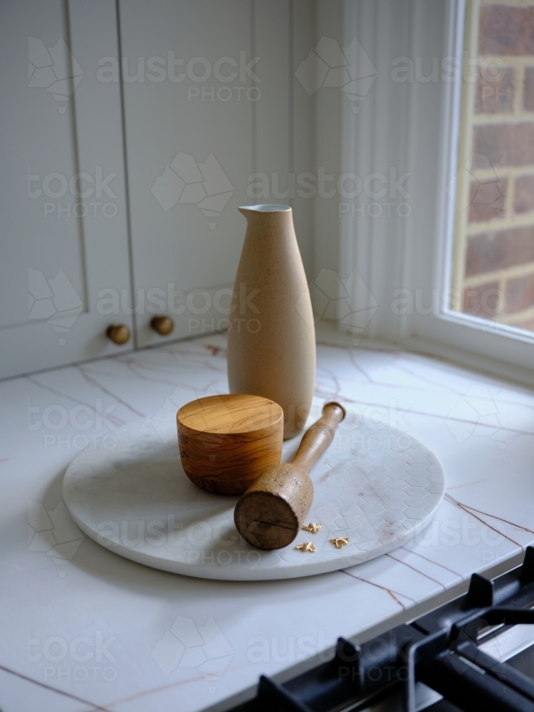 Jar and pot on a plate near the window - Australian Stock Image