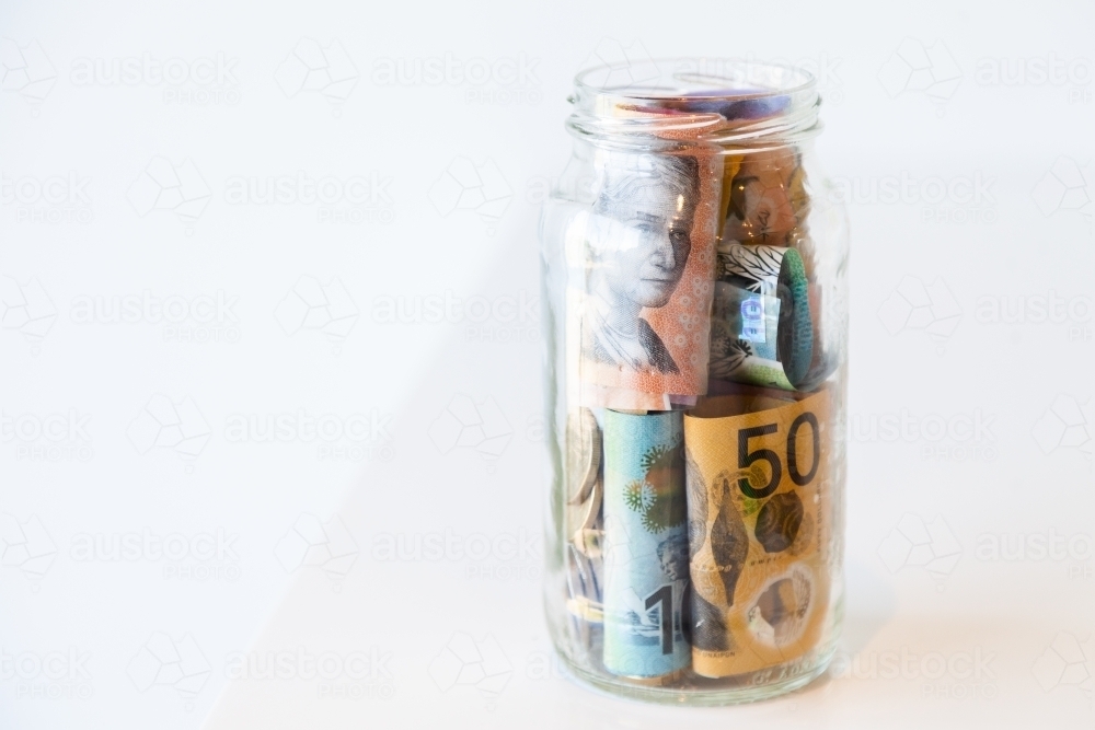Jar of Australian currency notes and coins - Australian Stock Image