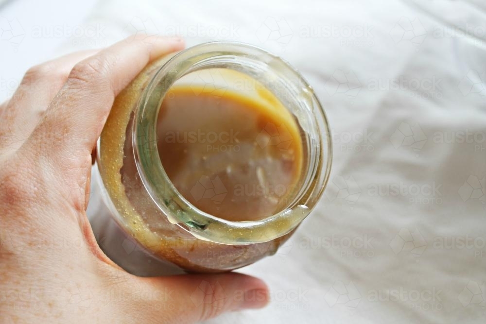 Jar of caramel sauce - Australian Stock Image