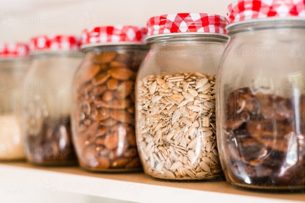 jars full of seeds and nuts - Australian Stock Image