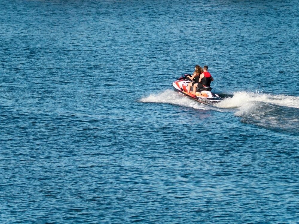 Jet ski speeding across water : Austockphoto Jet ski speeding across water - Australian Stock Image
