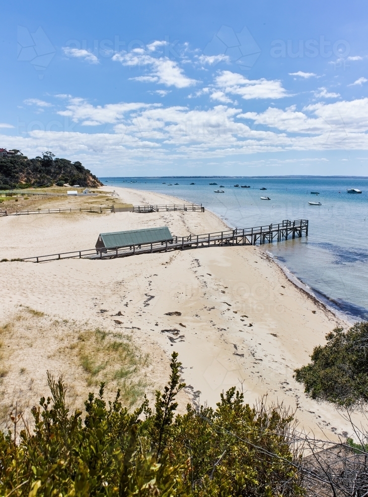 Jetty and shed with boats in background - Australian Stock Image