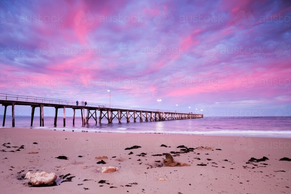 jetty at sunrise with pink cloudy sky - Australian Stock Image