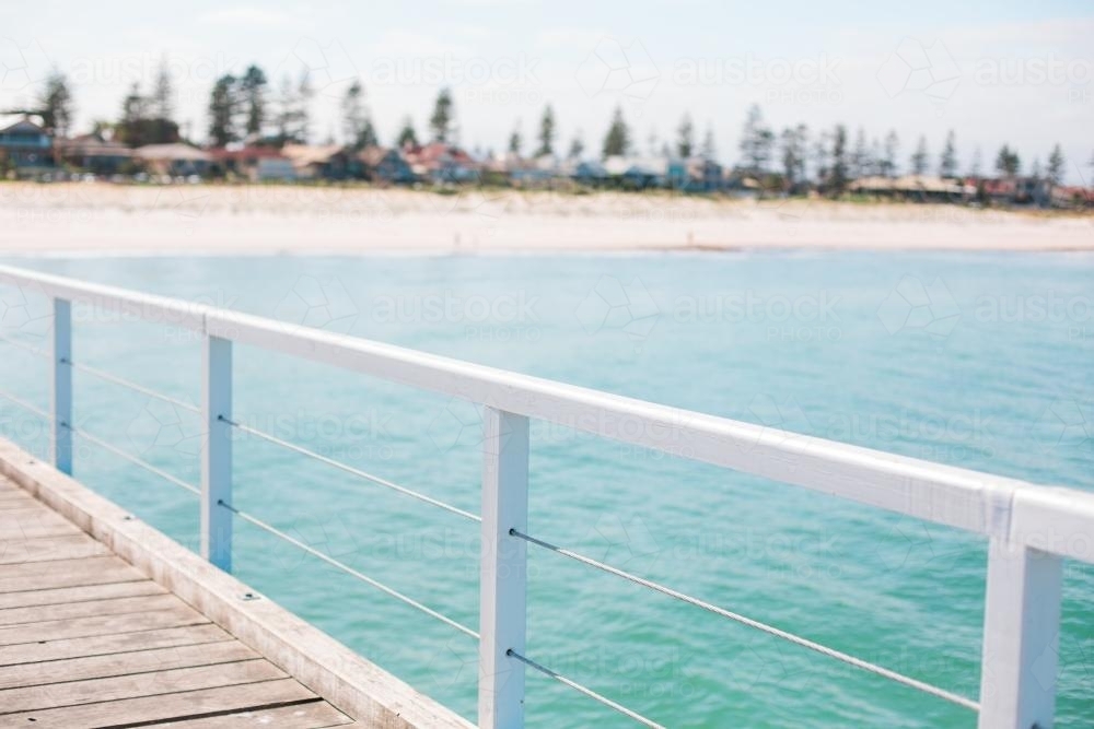 Seaside Railing Image of Jetty railing overlooking a beach - Austockphoto