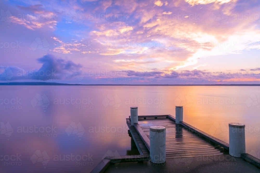 Jetty with vivid sunrise - Australian Stock Image
