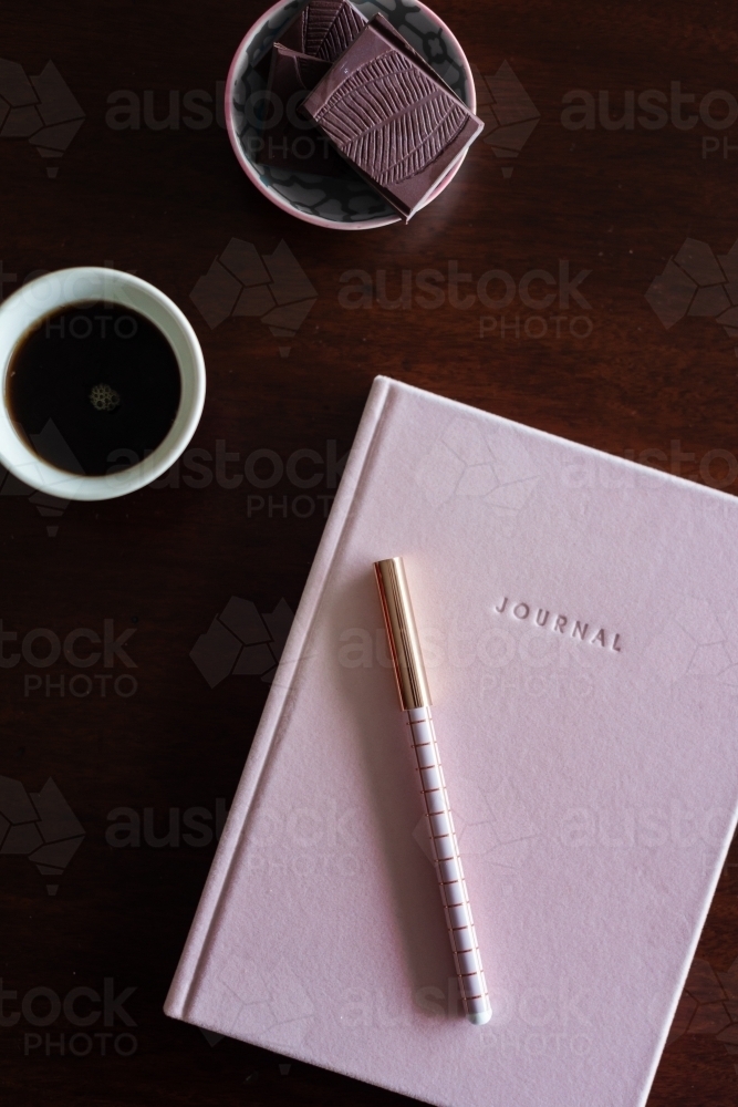 journal book with chocolate and coffee - Australian Stock Image