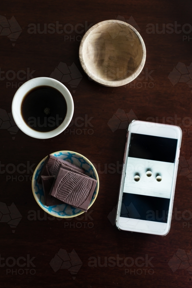 mobile phone with chocolate and coffee - Australian Stock Image