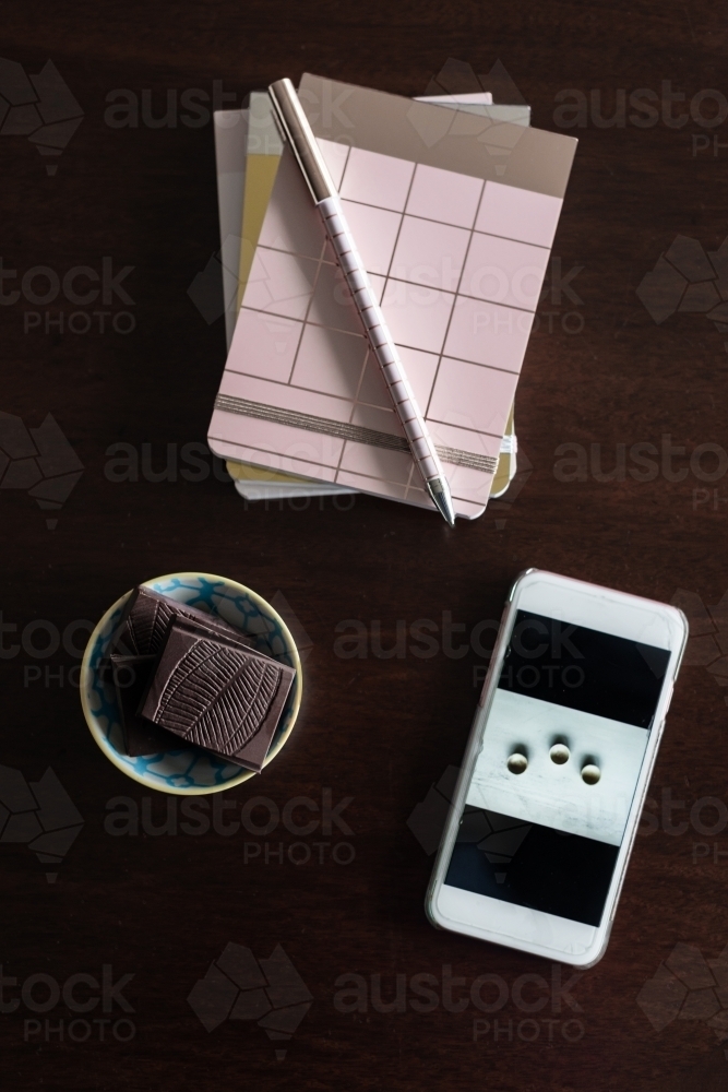 journal book with chocolate and mobile phone - Australian Stock Image