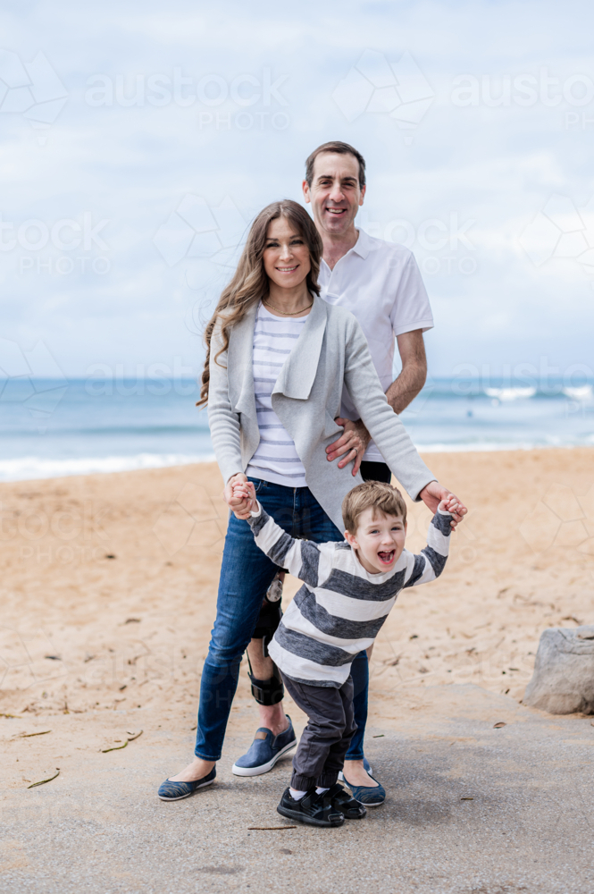 joyful family portrait at the beach - Australian Stock Image