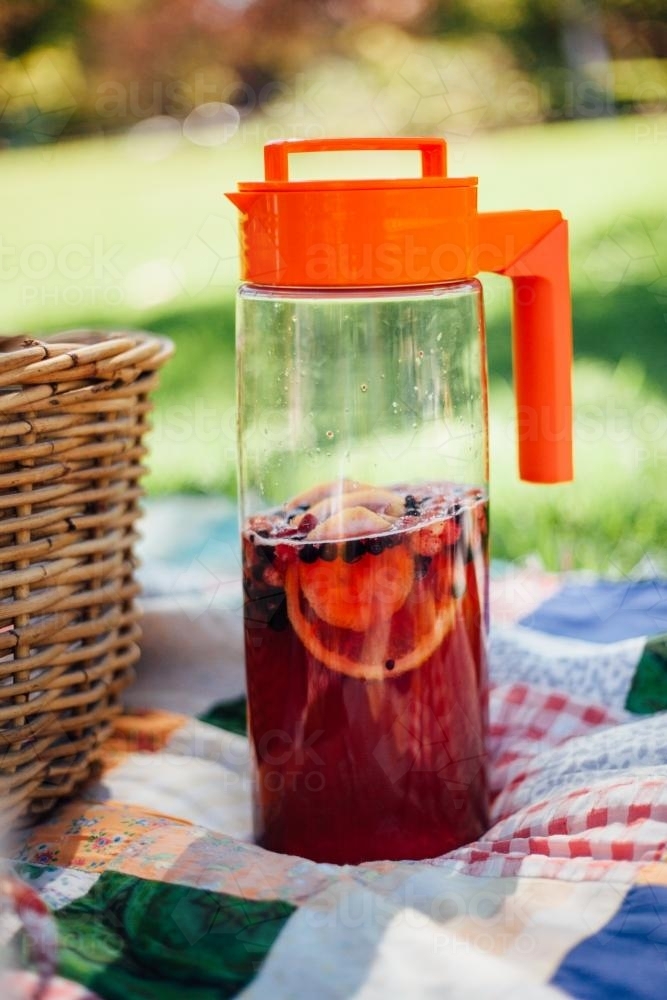 Jug of punch on picnic blanket - Australian Stock Image