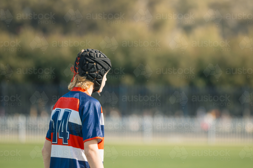 Image of Junior rugby union player on field wearing protective head ...