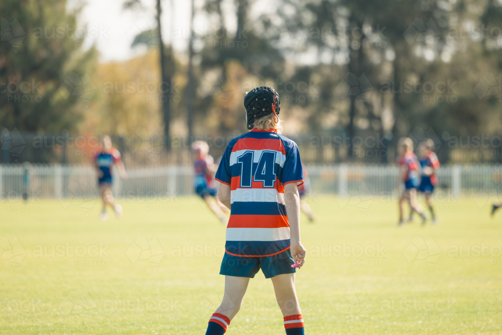 Junior rugby union player on field wearing protective head gear - Australian Stock Image