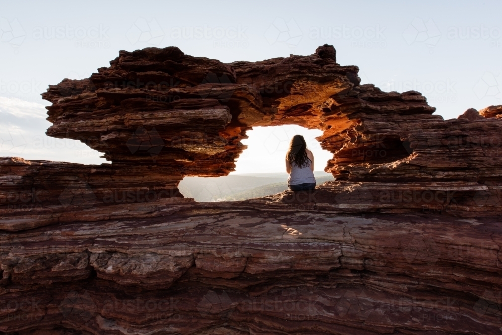 Kalbarri's Nature's Window with girl viewing the gorges at sunrise - Australian Stock Image